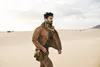 A man walks through a desert landscape. Produktbild-Vorschau