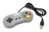 A gray USB game controller with colored buttons and a black cable, shown on a white background. Náhľad obrázku produktu