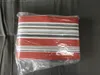 A striped awning fabric is shown in its packaging. Produktbild-Vorschau