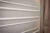 A close-up view of a wall with decorative white molding. Anteprima dell’immagine prodotto
