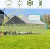 A large chicken coop with a metal frame and a gray roof, situated on a green lawn with various chickens and ducks inside and around it. The image also features marketing icons at the top indicating weather resistance and temperature regulation. Produktbild-Vorschau