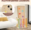 A wooden climbing toy with colorful rungs and climbing holds is set up indoors next to a white sofa. A close-up inset shows the adjustable knobs on the toy. Produktbild-Vorschau