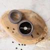 A coffee grinder with coffee beans on a wooden board. Náhľad obrázku produktu