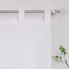A close-up view of a white curtain with tab tops hanging from a metal curtain rod. Produktbild-Vorschau