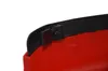 A close-up view of a red plastic object with a black trim and a small screw attaching it. Náhled obrázku produktu
