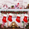 Christmas stockings hanging on a fireplace mantel. Podgląd zdjęcia produktu