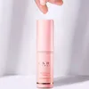 A hand is about to touch a pink cosmetic balm stick. Náhled obrázku produktu