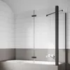A modern bathroom with a bathtub and a glass shower screen. Anteprima dell’immagine prodotto
