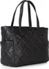 A black quilted handbag is shown from a side angle against a white background. Náhľad obrázku produktu