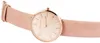 A close-up, side view of a women's analog wristwatch with a rose gold case and a light pink leather strap. Produktbild-Vorschau