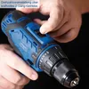 A close-up shot of a person's hands operating a cordless drill. Voir les images du produit