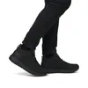 A person wearing black jeans and black boots. Anteprima dell’immagine prodotto