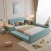 A child's bedroom with a blue upholstered bed, desk, and stool, along with toys and a teepee. Voir les images du produit