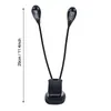 A black clip-on LED reading light with two adjustable gooseneck arms, each with a light head containing multiple LEDs. The base has a clip mechanism. Voir les images du produit