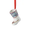 A porcelain Christmas stocking ornament hanging by a red ribbon. Produktbild-Vorschau