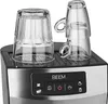 Close-up of the top of an espresso machine with two glass cups on top. Produktbild-Vorschau