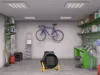 A garage or workshop setting with a bicycle mounted on the wall, shelves with items, and a portable heater in the foreground. Produktbild-Vorschau