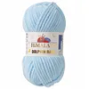 A ball of light blue yarn with a label. Podgląd zdjęcia produktu