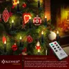 Christmas tree decorated with LED candles and ornaments, with a fireplace in the background. Produktbild-Vorschau