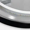 A close-up view of the edge of a round mirror, showing the LED strip lights embedded in the frame. Anteprima dell’immagine prodotto