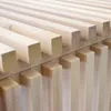 A close-up view of a wooden bench with parallel slats. Produktbild-Vorschau