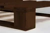 A close-up view of a dark brown wooden bed frame, focusing on the corner support and slats. Produktbild-Vorschau