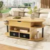 A modern wooden coffee table with storage drawers and shelves is placed in a living room setting, in front of a cream-colored sofa. Produktbild-Vorschau