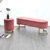 A pink velvet ottoman and bench with gold metal legs are displayed on a gray wooden floor. Náhľad obrázku produktu