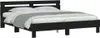 A black bed frame with a mattress and bedding, shown against a white background. Náhled obrázku produktu