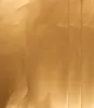 A close-up, full-frame shot of a textured, golden material, likely paper or foil, with visible creases and folds. Náhľad obrázku produktu