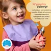 A young girl is smiling and holding a set of children's cutlery with pink handles. Voir les images du produit