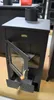 A black wood-burning stove with its door open, displaying a drawer and the interior. A metal pipe is attached to the top. Anteprima dell’immagine prodotto