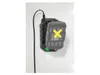 A battery charger mounted on a wall, with a battery inserted. Produktbild-Vorschau