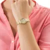 A close-up shot of a woman's wrist wearing a gold watch. Anteprima dell’immagine prodotto