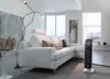 A modern living room with a white sectional sofa, a tall floor lamp, and a black electric heater on the floor. Anteprima dell’immagine prodotto
