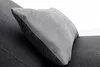 A close-up shot of a gray cushion on a dark gray sofa. Produktbild-Vorschau