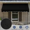 A black awning is installed over a window on a house, with a small table and chair set on the patio below. A close-up inset shows the fabric texture with water droplets. Anteprima dell’immagine prodotto