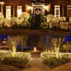 A collage of two images showing a house decorated with Christmas lights and a garden path with lights and a fountain. Náhled obrázku produktu