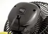 A close-up view of the back of a black fan, showing the power switch and the cord. Náhled obrázku produktu