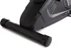 Close-up view of the base of a black exercise bike, focusing on the front stabilizer bar and part of the main body. Produktbild-Vorschau