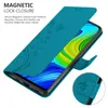 A teal flip case for a smartphone, with floral embossed patterns, is shown open, revealing the phone screen. Náhled obrázku produktu