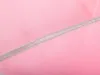 A close-up view of pink mesh fabric with a gray stitched edge. Produktbild-Vorschau