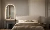 A bedroom scene with a bed, a vanity with a mirror, and a stool. Produktbild-Vorschau