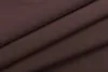 A close-up view of folded brown fabric, likely curtains, with soft lighting. Produktbild-Vorschau