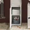 A close-up of a white bathroom cabinet with shelves, holding folded towels and toiletries. The cabinet is open, revealing its contents. Produktbild-Vorschau