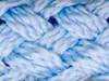A close-up, macro view of a braided rope, showing the texture and weave of the material. Produktbild-Vorschau