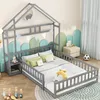 A child's bed with a house frame, bedding, and a bedside table in a room. Podgląd zdjęcia produktu