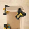 Two corner clamps are shown holding together pieces of wood at a right angle. Produktbild-Vorschau