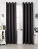A pair of dark gray curtains hanging in front of a window, with a white dresser and a small table with decorative items visible on either side. Produktbild-Vorschau