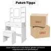 A white dressing table with a mirror and stool, next to two cardboard boxes labeled 'BOX A' and 'BOX B'. The text at the bottom explains the item is delivered in two boxes and may not arrive at the same time. Náhled obrázku produktu